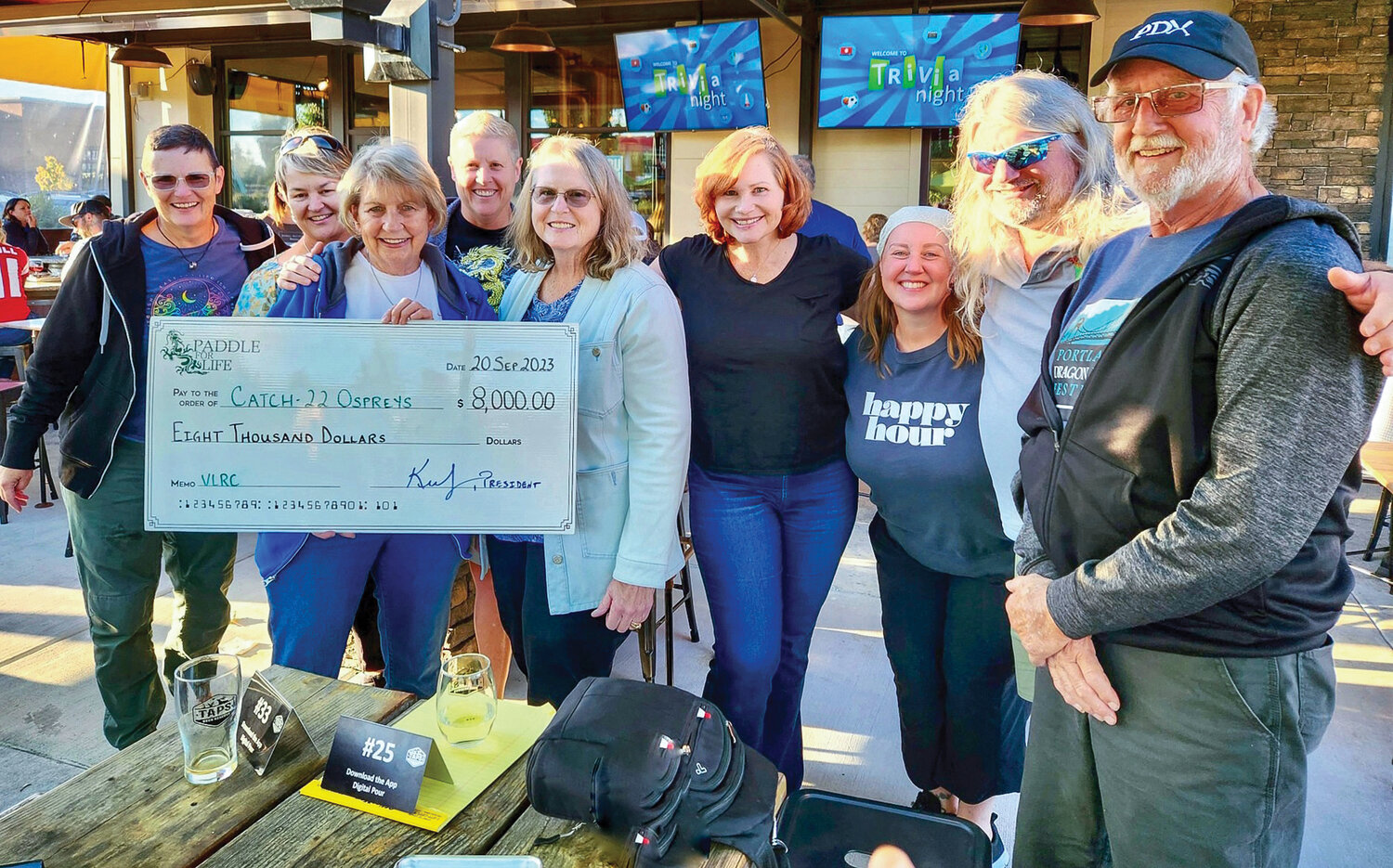 Members of the Catch-22 Breast Cancer Survivors Dragon Boat team are presented with a ceremonial check for $8,000 from Paddle For Life following a fundraiser in Ridgefield last month. The money will be used to build and maintain a breast cancer survivor’s paddling community in southwest Washington, according to a press release.